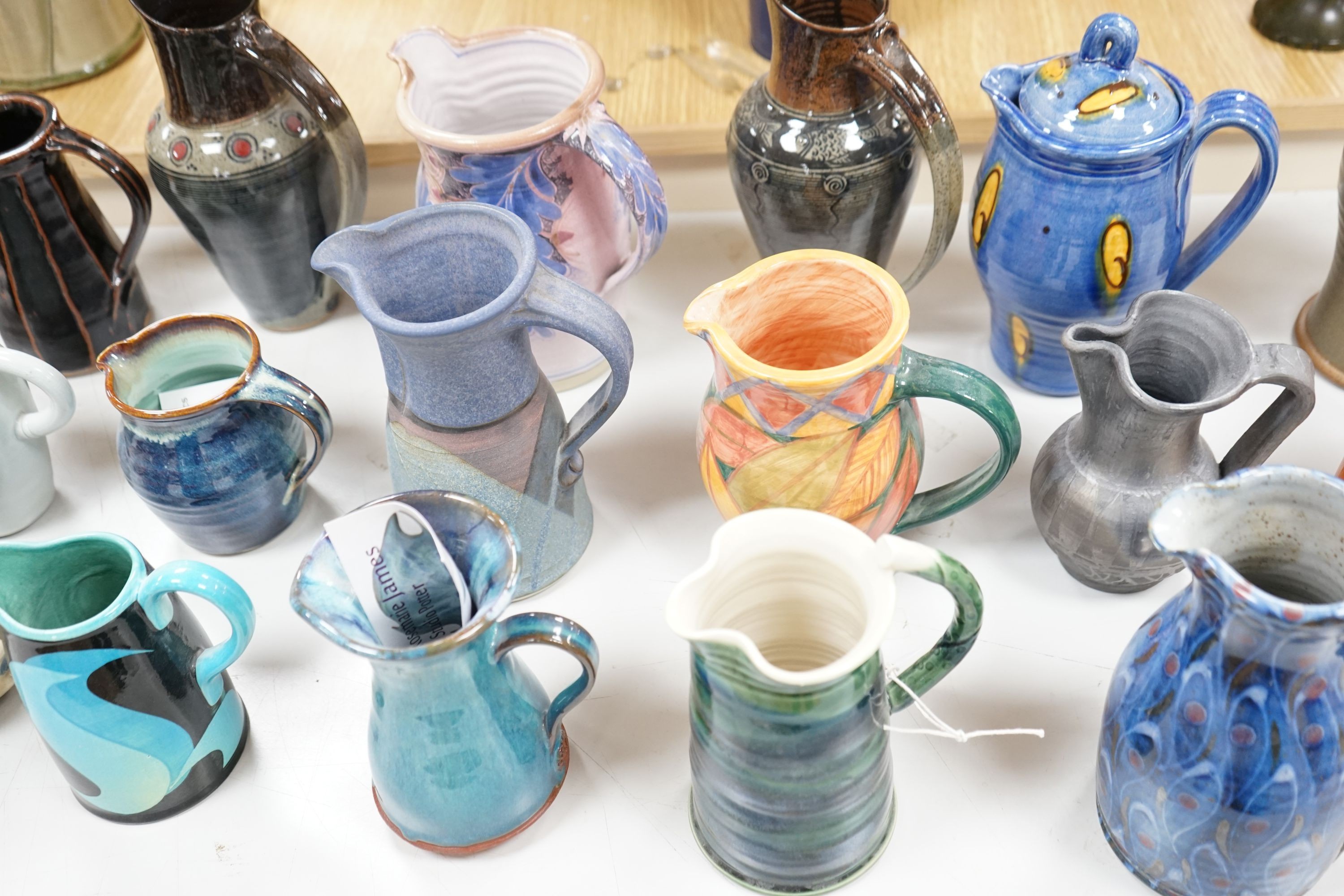 A group of studio pottery jugs to include - 27cm